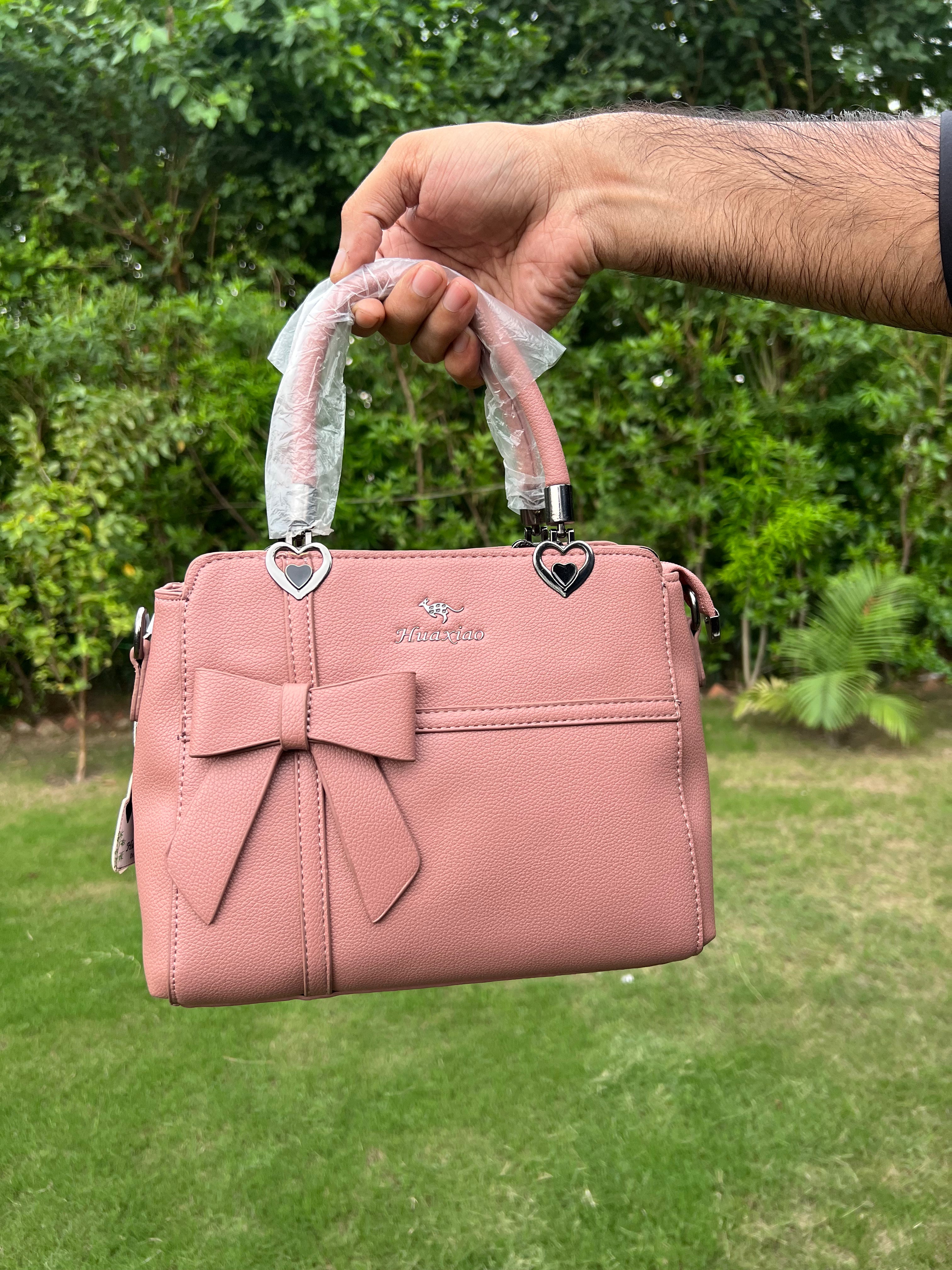 Elegant Pink Bow Handbag with Heart Handle Accents