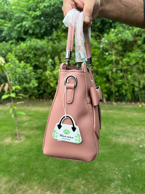 Elegant Pink Bow Handbag with Heart Handle Accents