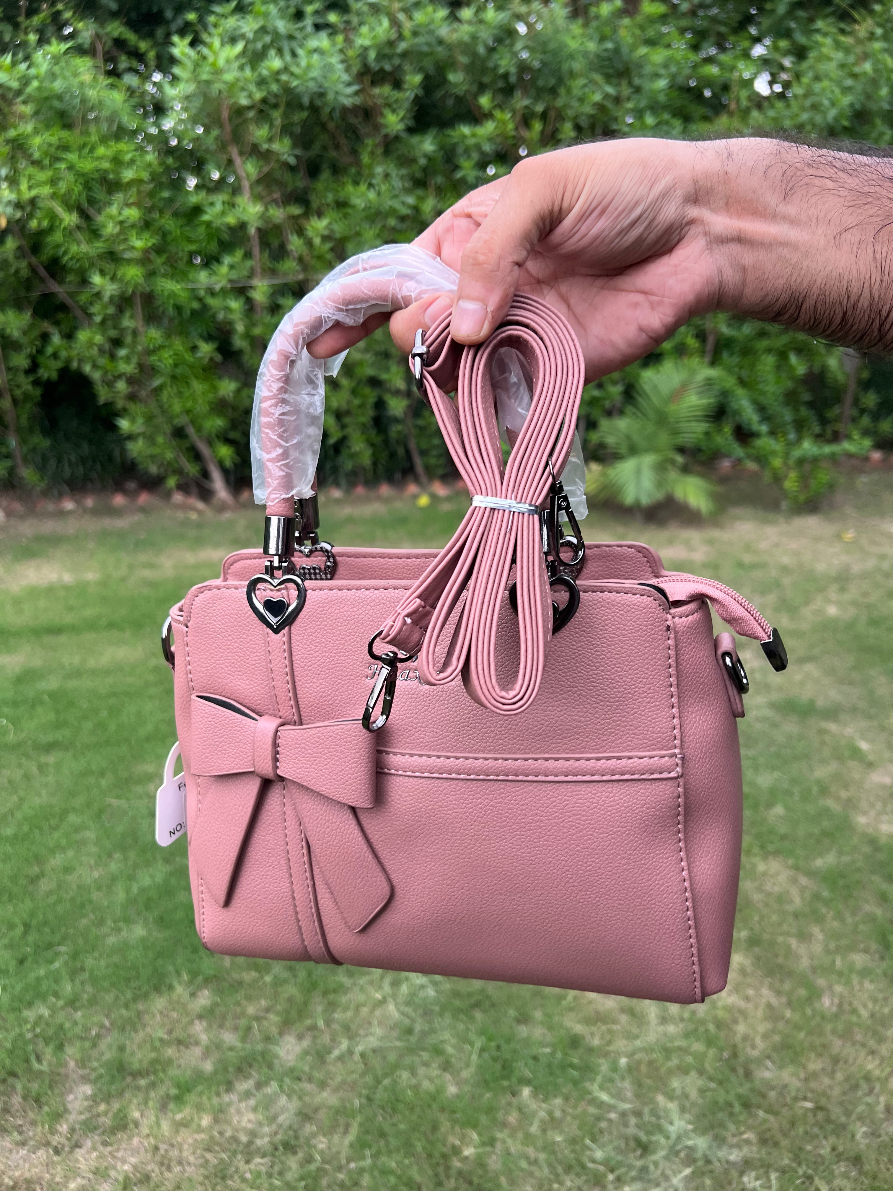 Elegant Pink Bow Handbag with Heart Handle Accents